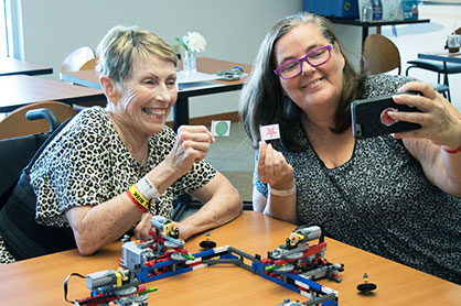 An elderly female patient using Legos as part of her neuro therapy.