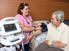 Therapist taking a patient's blood pressure reading.